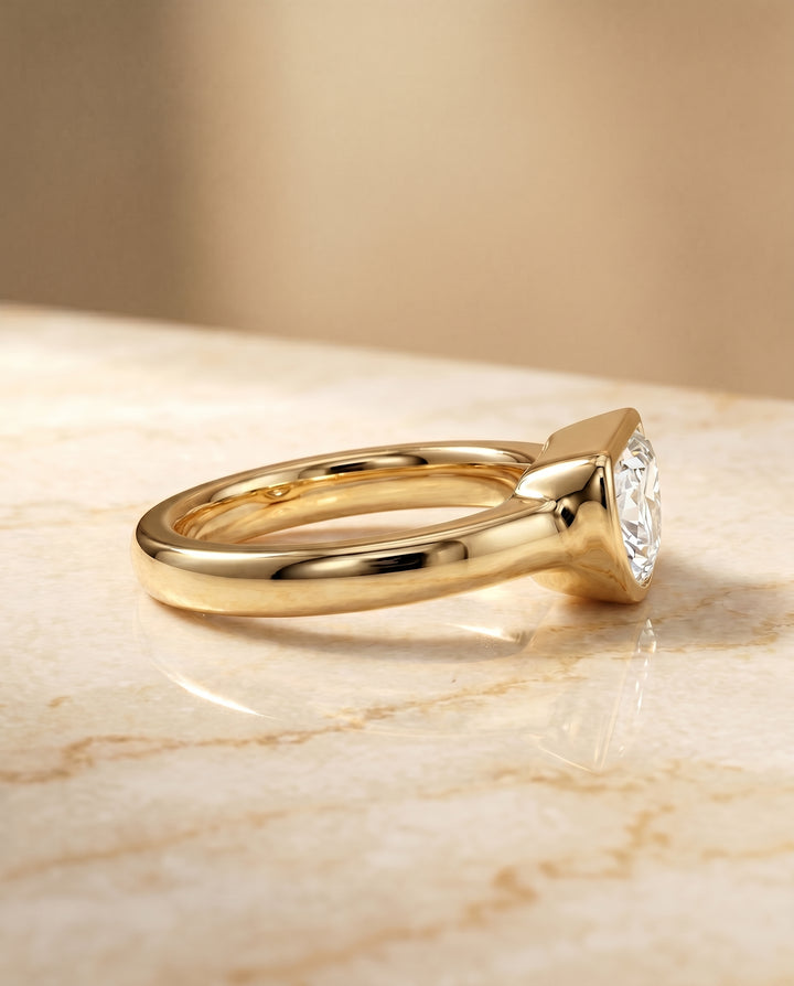 The Agnes Bezel Solitaire In Half Moon Engagement Ring Setting in 18K Yellow Gold