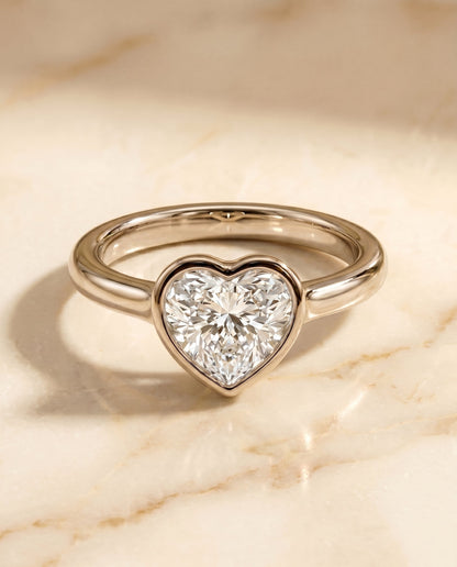 Agnes Select Bezel Solitaire In Heart Lab Diamond Engagement Ring in Platinum, shown on hand, angled | RockHer