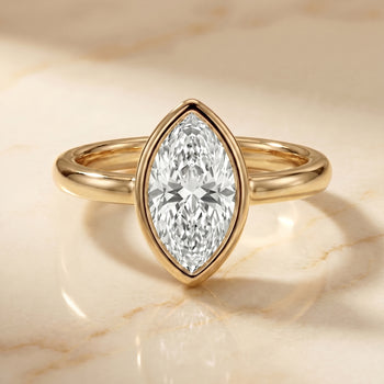 The Agnes Bezel Solitaire In Marquise Engagement Ring Setting in 18K Yellow Gold