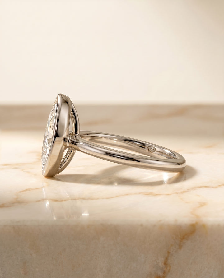 The Agnes Bezel Solitaire In Marquise Engagement Ring Setting in 18K White Gold