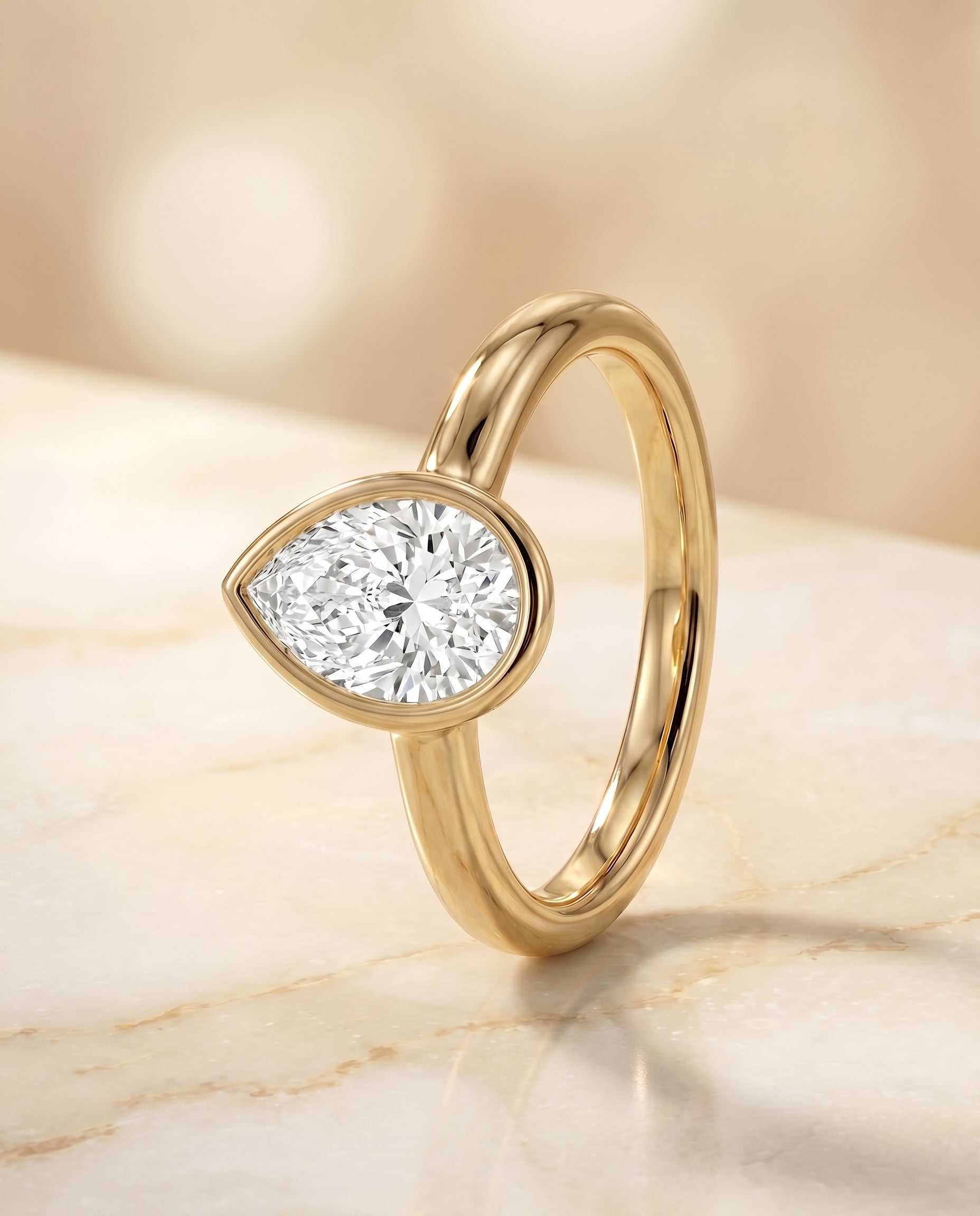 Bezel Solitaire In styling on The Agnes pear engagement ring setting | RockHer