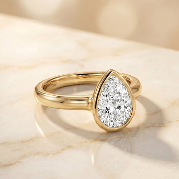 The Agnes Bezel Solitaire In Pear Engagement Ring Setting in 18K Yellow Gold