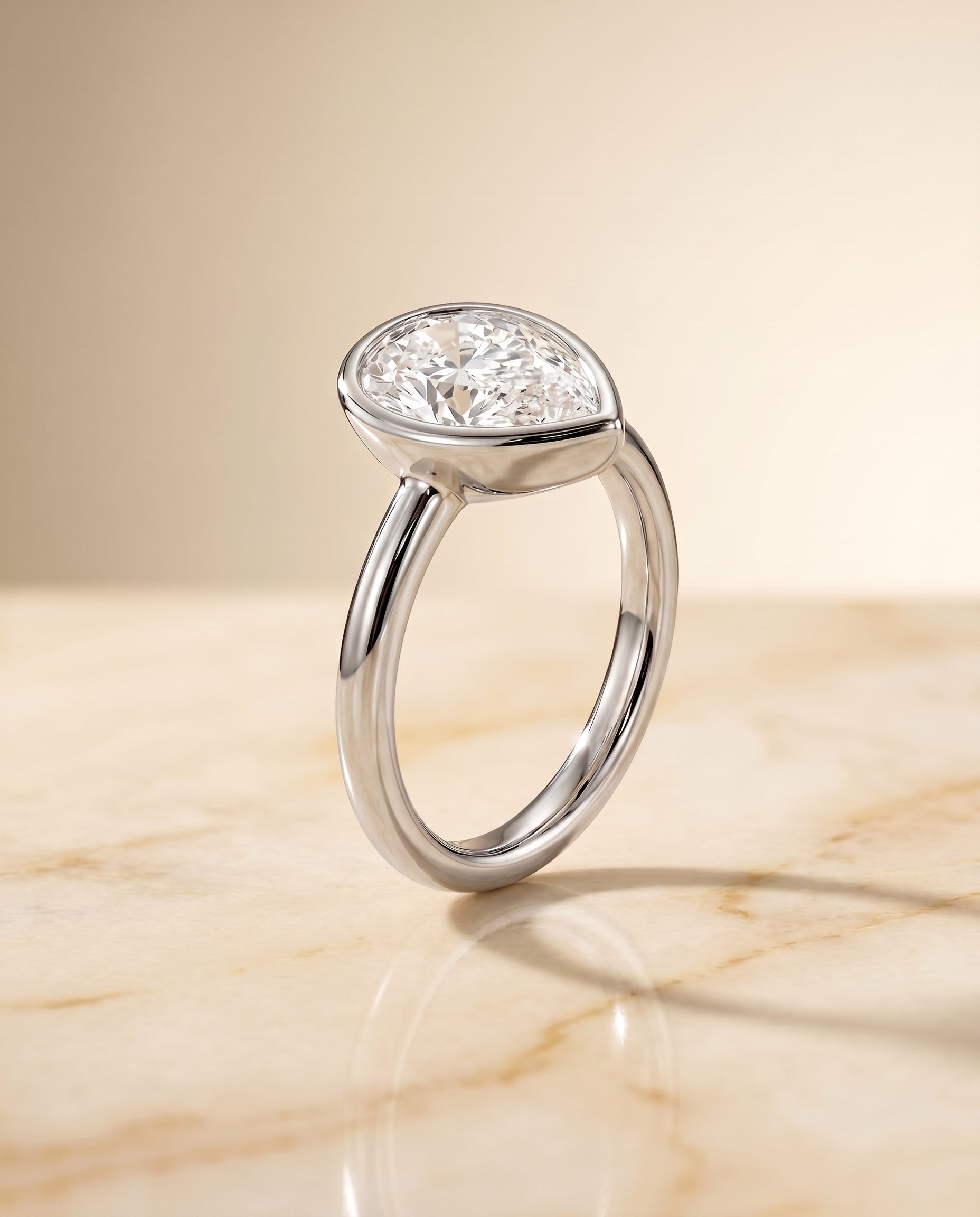 Bezel Solitaire In styling on The Agnes pear engagement ring setting | RockHer