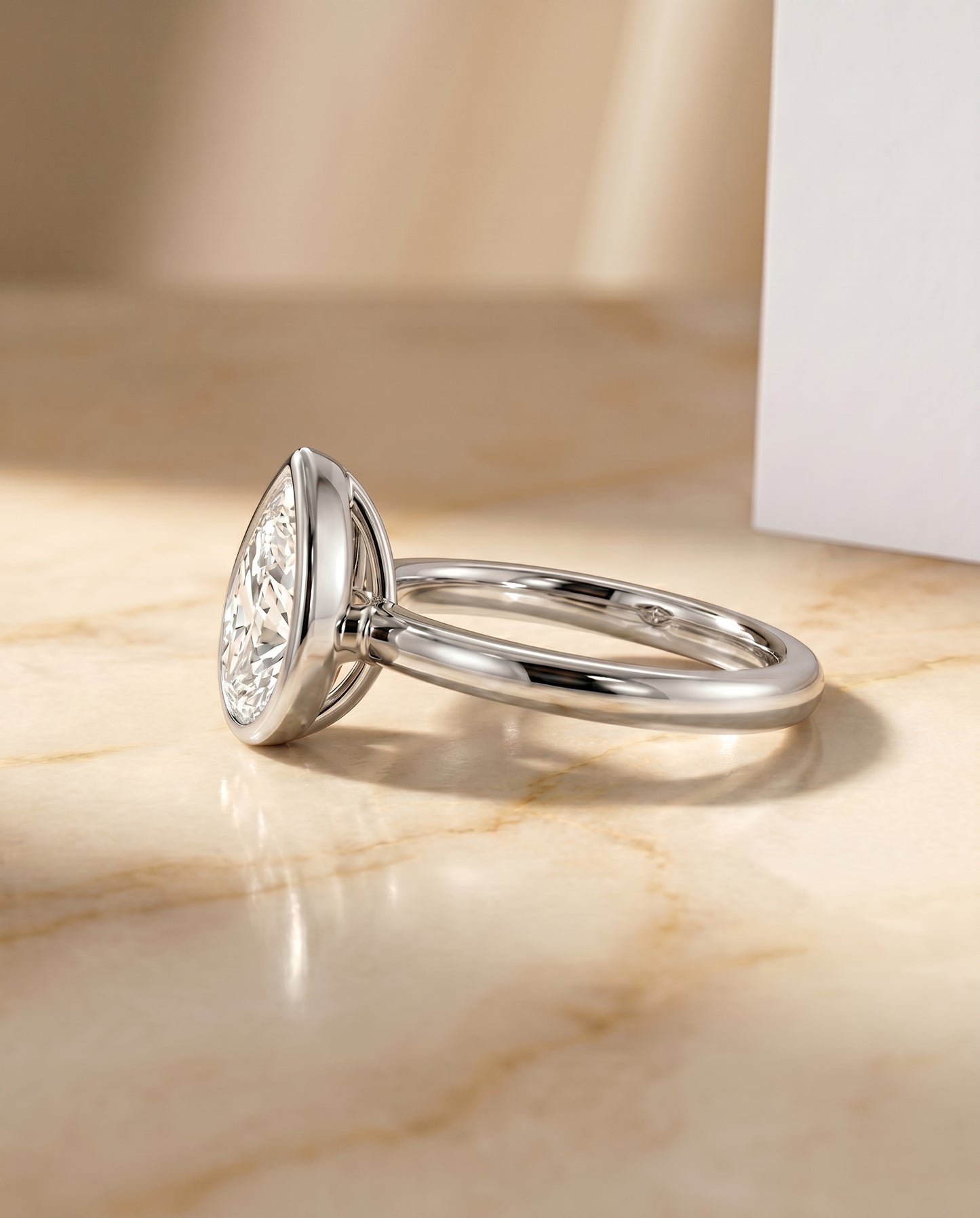 The Agnes Bezel Solitaire In Pear Engagement Ring Setting in Platinum