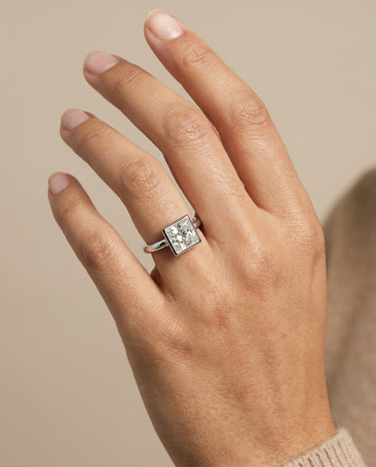 The Agnes Bezel Solitaire In Princess Cut Engagement Ring Setting in 18K White Gold