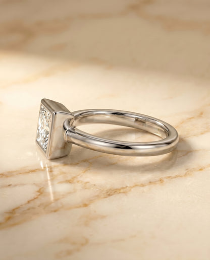 The Agnes Bezel Solitaire In Princess Cut Engagement Ring Setting in 18K White Gold