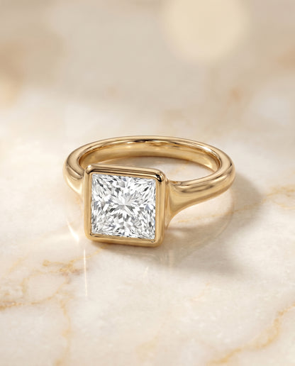 The Agnes Bezel Solitaire In Princess Cut Engagement Ring Setting in 18K Yellow Gold
