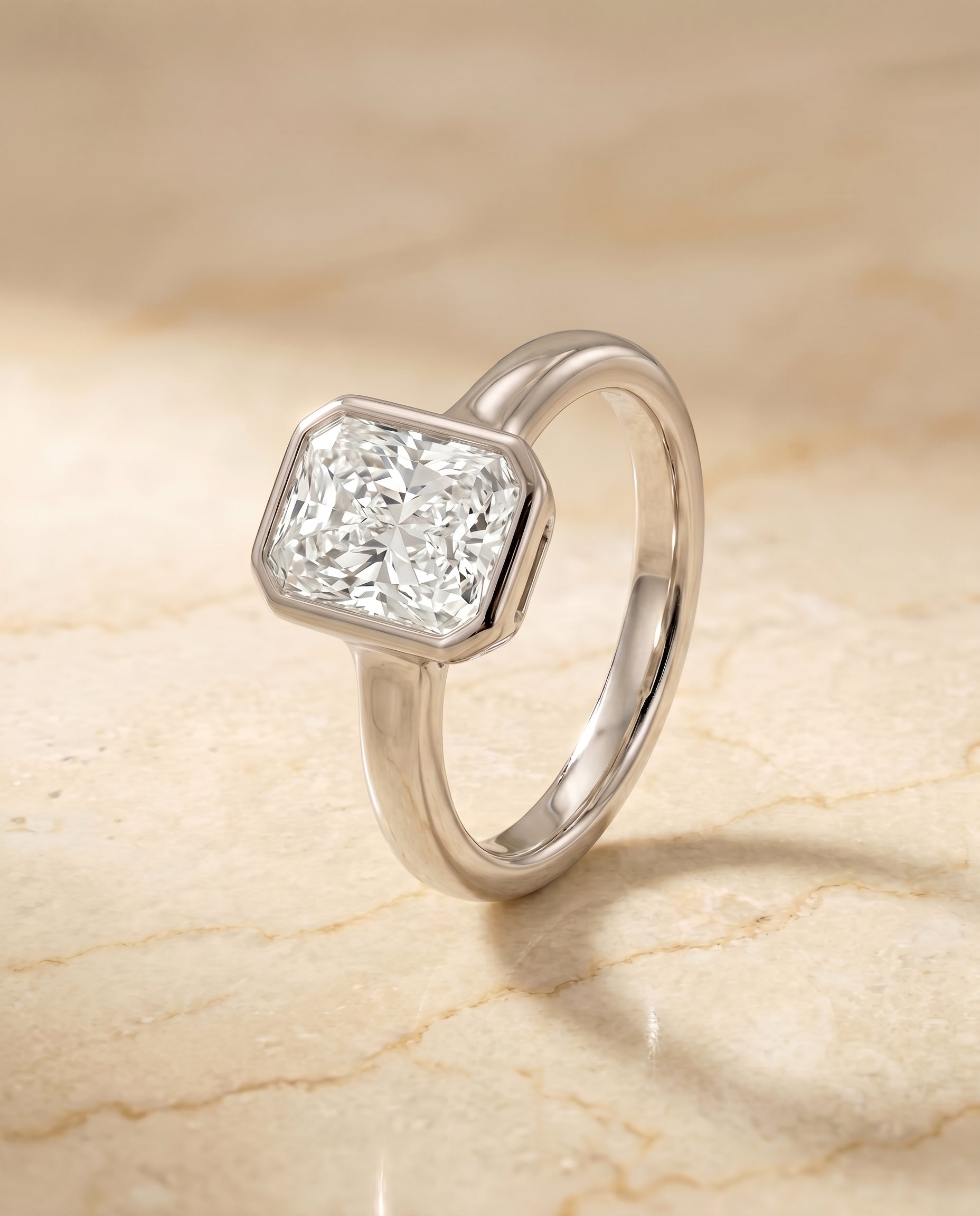 Bezel Solitaire In Cut styling on The Agnes radiant engagement ring setting | RockHer