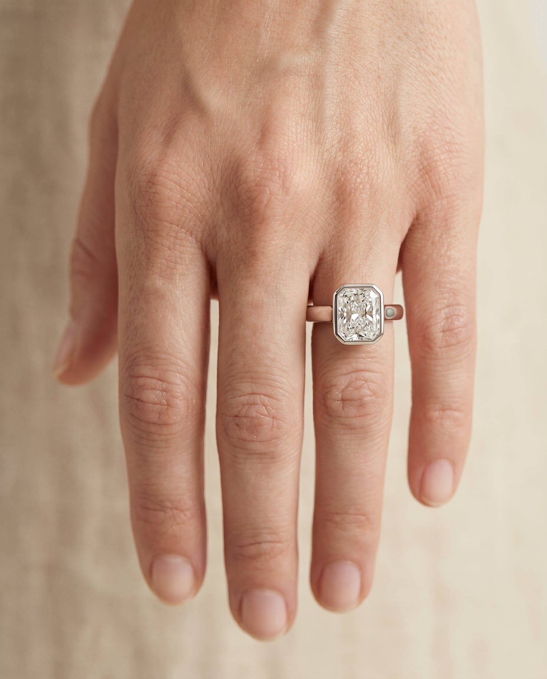 The Agnes engagement ring setting in Platinum, bezel solitaire in cut design | RockHer