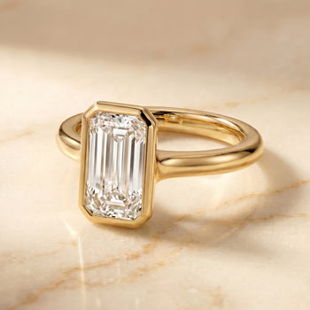 The Agnes Bezel Solitaire In Tapered Baguette Engagement Ring Setting in 18K Yellow Gold