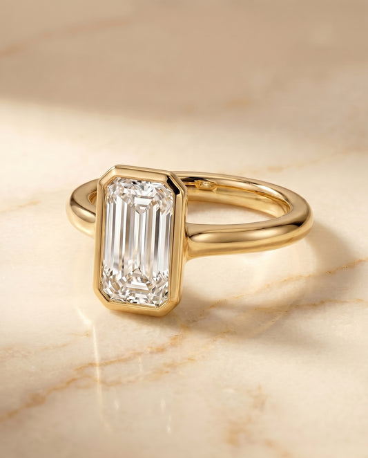 The Agnes Bezel Solitaire Engagement Ring Setting for Tapered Baguette Diamonds in 18K Yellow Gold