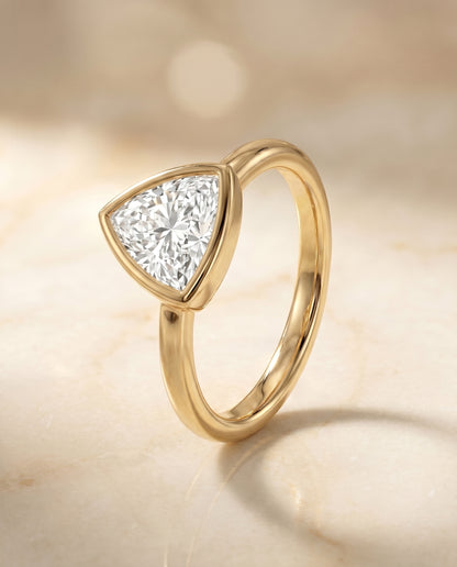 The Agnes Bezel Solitaire In Trillion Engagement Ring Setting in 18K Yellow Gold
