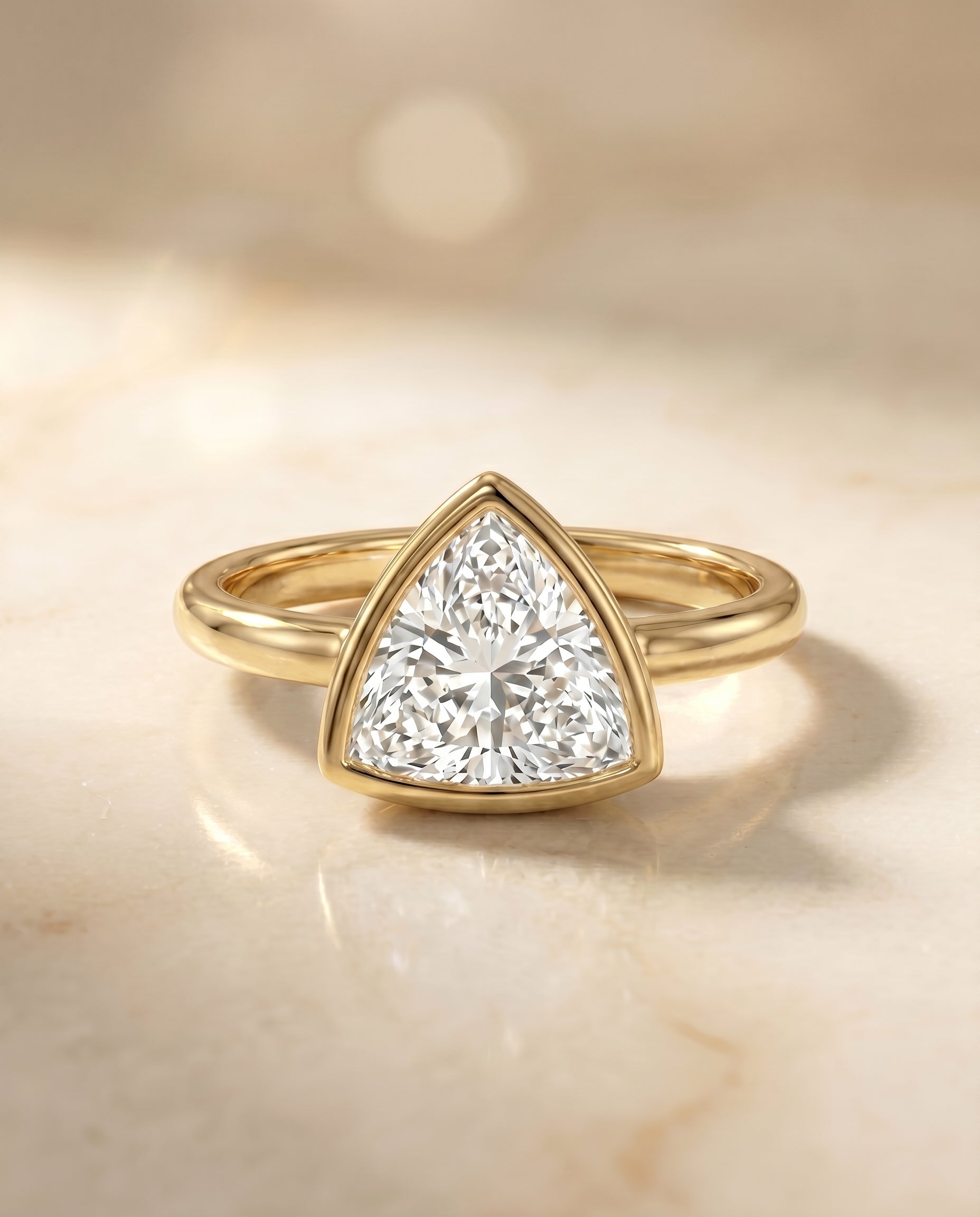 The Agnes Bezel Solitaire In Trillion Engagement Ring Setting in 18K Yellow Gold
