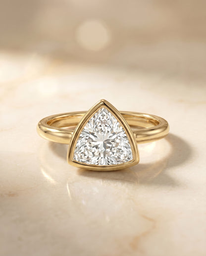 The Agnes Bezel Solitaire In Trillion Engagement Ring Setting in 18K Yellow Gold