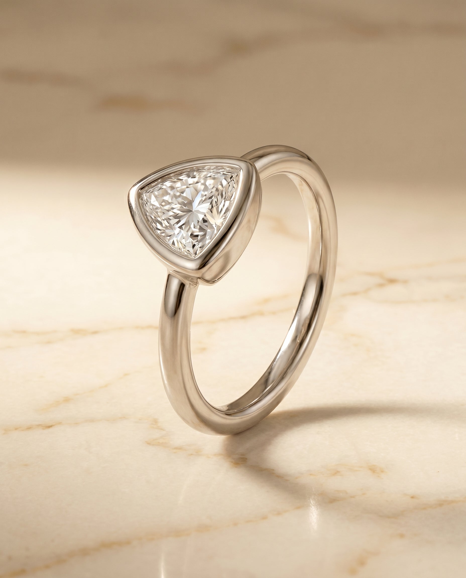 Bezel Solitaire In styling on The Agnes trillion engagement ring setting | RockHer