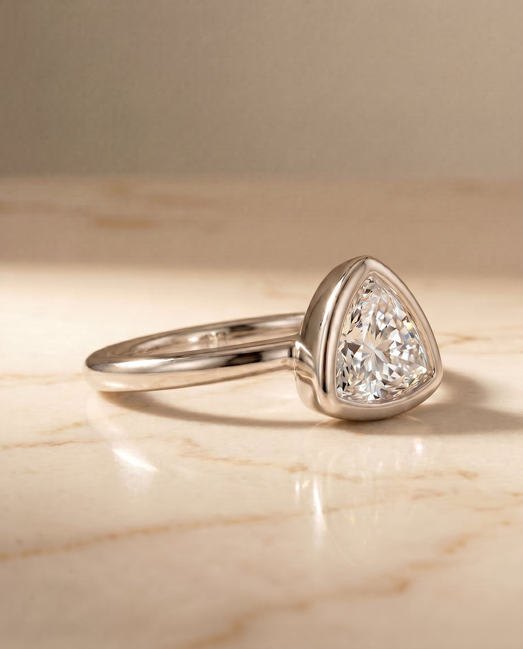The Agnes Select Bezel Solitaire Trillion Lab Diamond Engagement Ring in Platinum