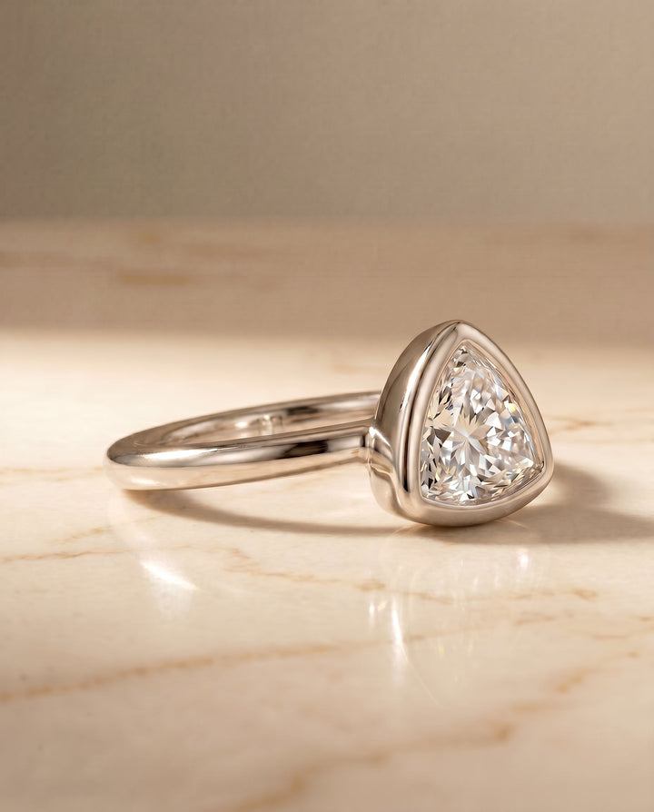 Agnes Select Bezel Solitaire In Trillion Lab Diamond Engagement Ring in 18K White Gold, shown on hand, angled | RockHer