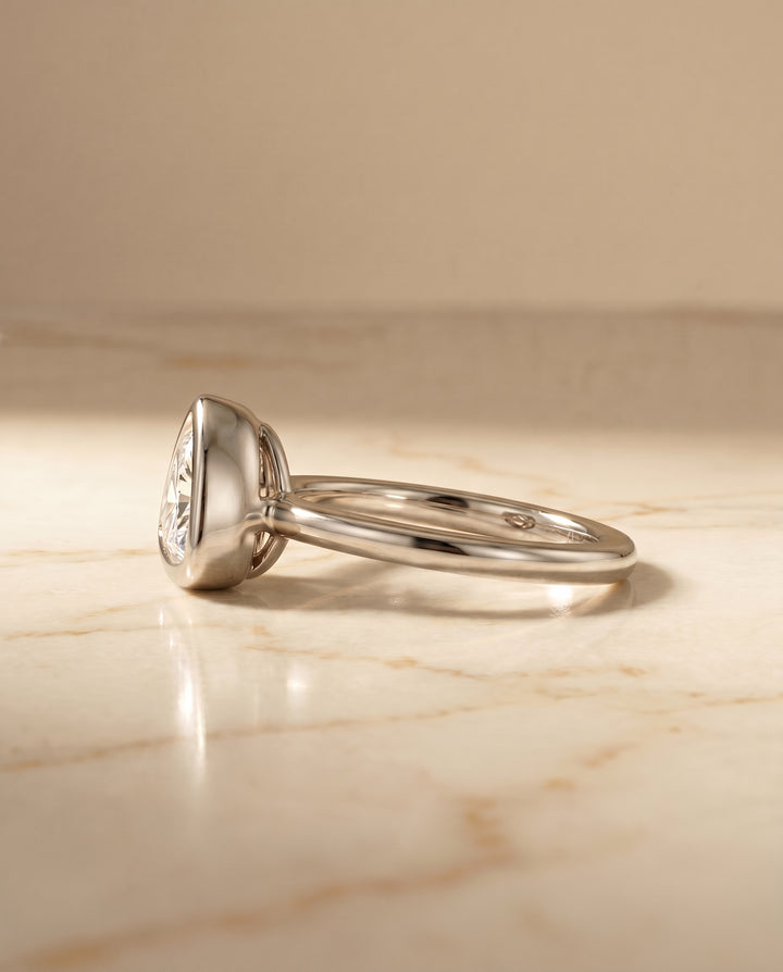 The Agnes Bezel Solitaire In Trillion Engagement Ring Setting in Platinum