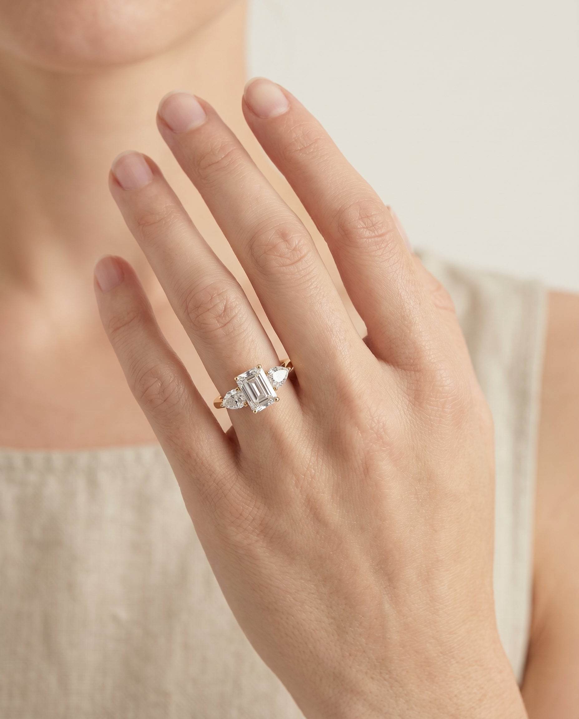 Angelica Select Three Stone Emerald Cut Lab Diamond Engagement Ring in 18K Yellow Gold, shown on hand | RockHer