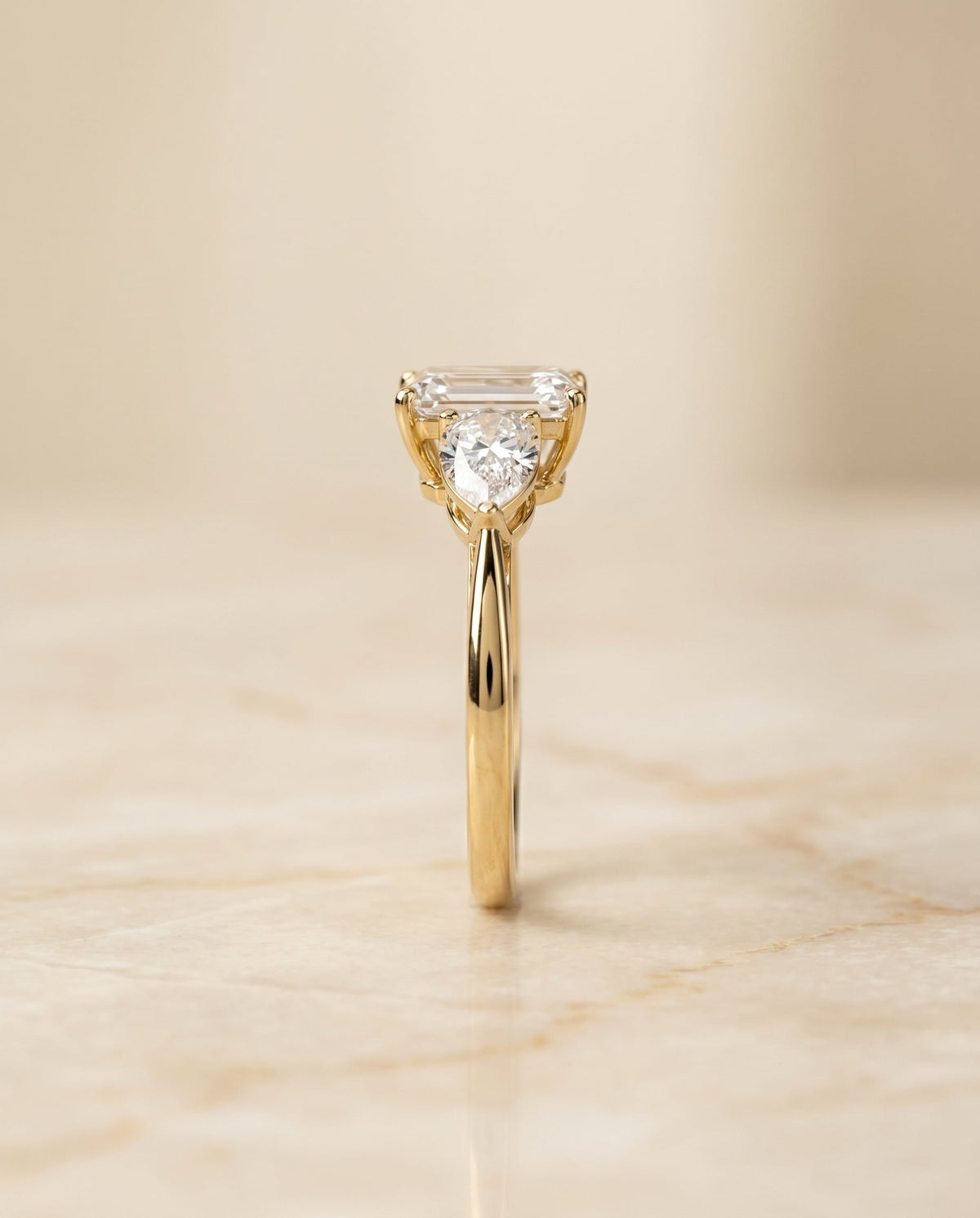 Angelica Select Three Stone Emerald Cut Lab Diamond Engagement Ring in 18K Yellow Gold, side view | RockHer