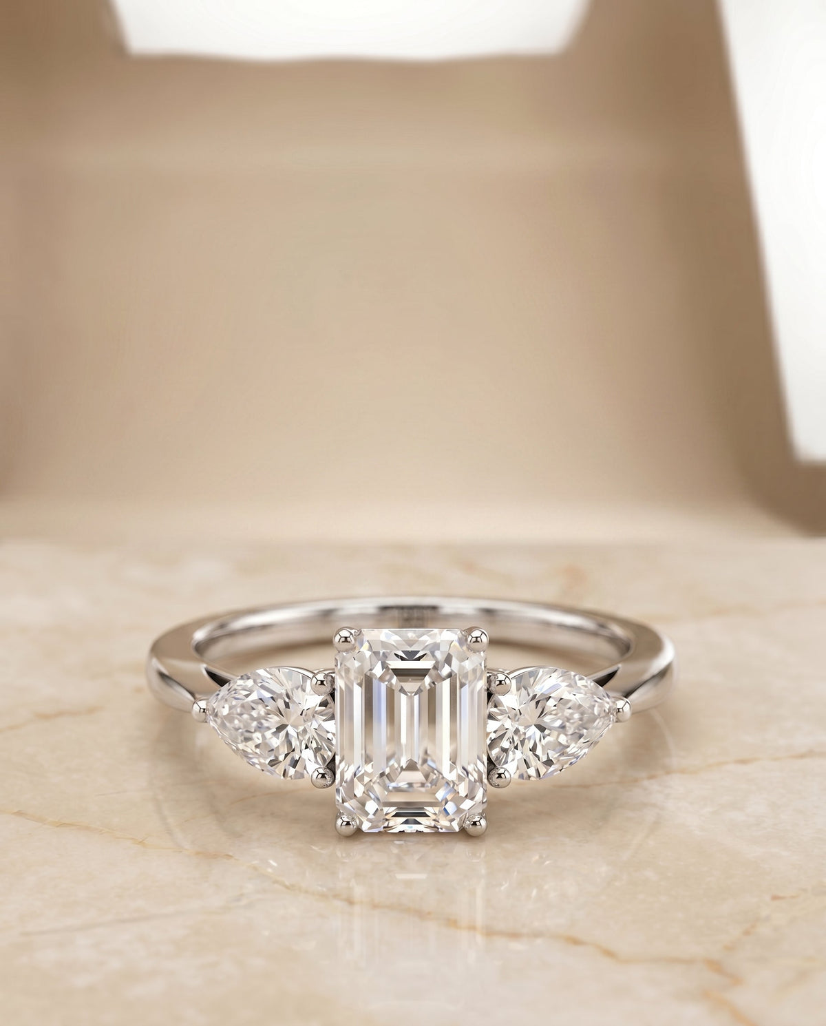 Angelica Select Three Stone Emerald Cut Lab Diamond Engagement Ring in 18K White Gold, shown on hand, angled | RockHer