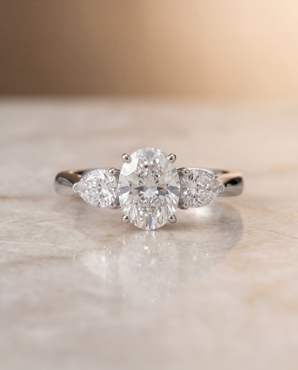 Angelica Select Three Stone Oval Lab Diamond Engagement Ring in Platinum, shown on hand, angled | RockHer