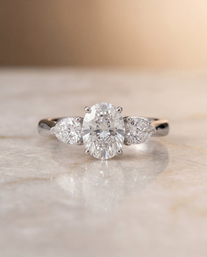 Angelica Select Three Stone Oval Lab Diamond Engagement Ring in Platinum, shown on hand, angled | RockHer