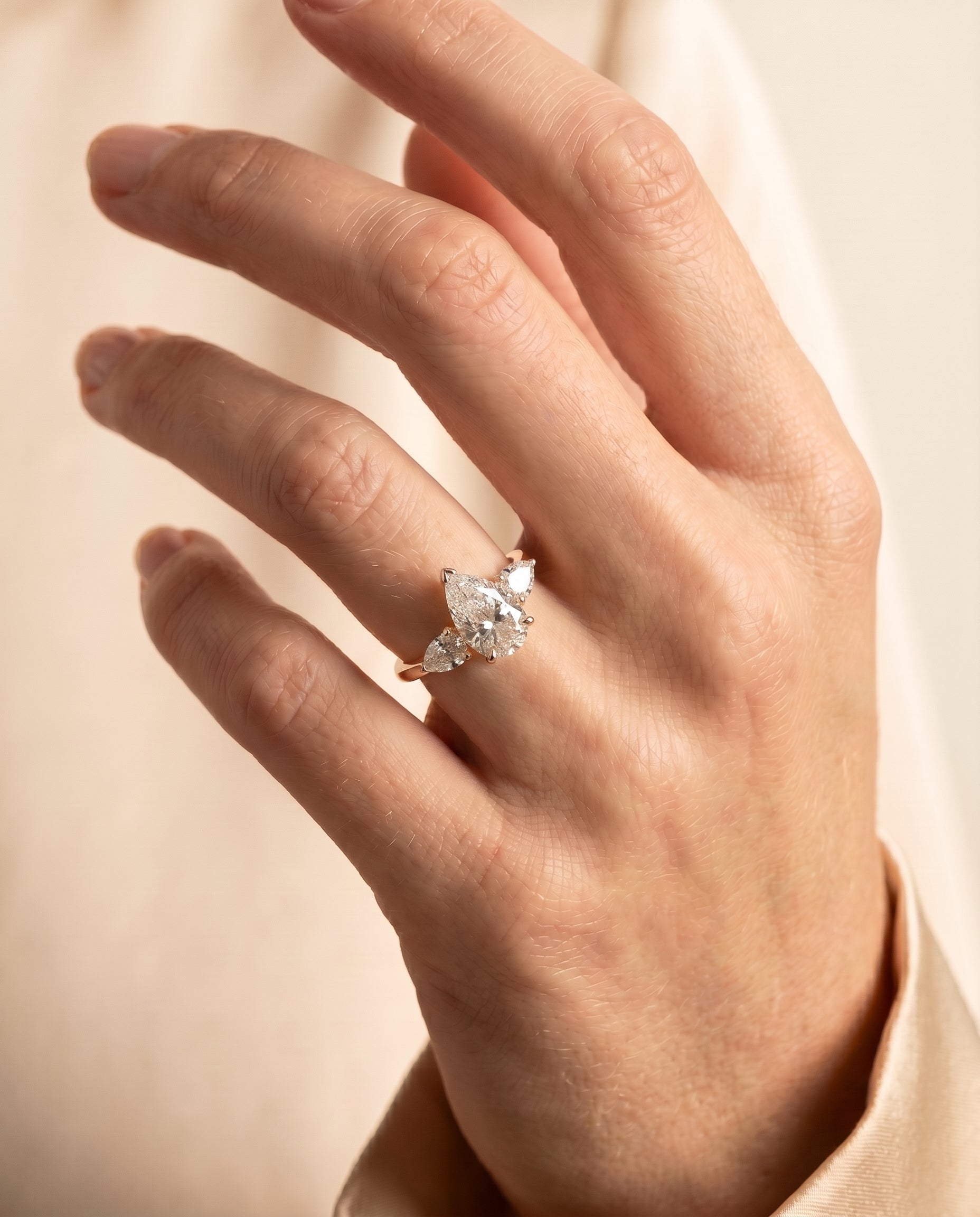 Angelica Select Three Stone Pear Lab Diamond Engagement Ring in 18K Yellow Gold, shown on hand | RockHer