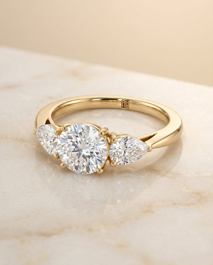 Angelica Select Three Stone Round Lab Diamond Engagement Ring in 18K Yellow Gold, shown on hand, angled | RockHer