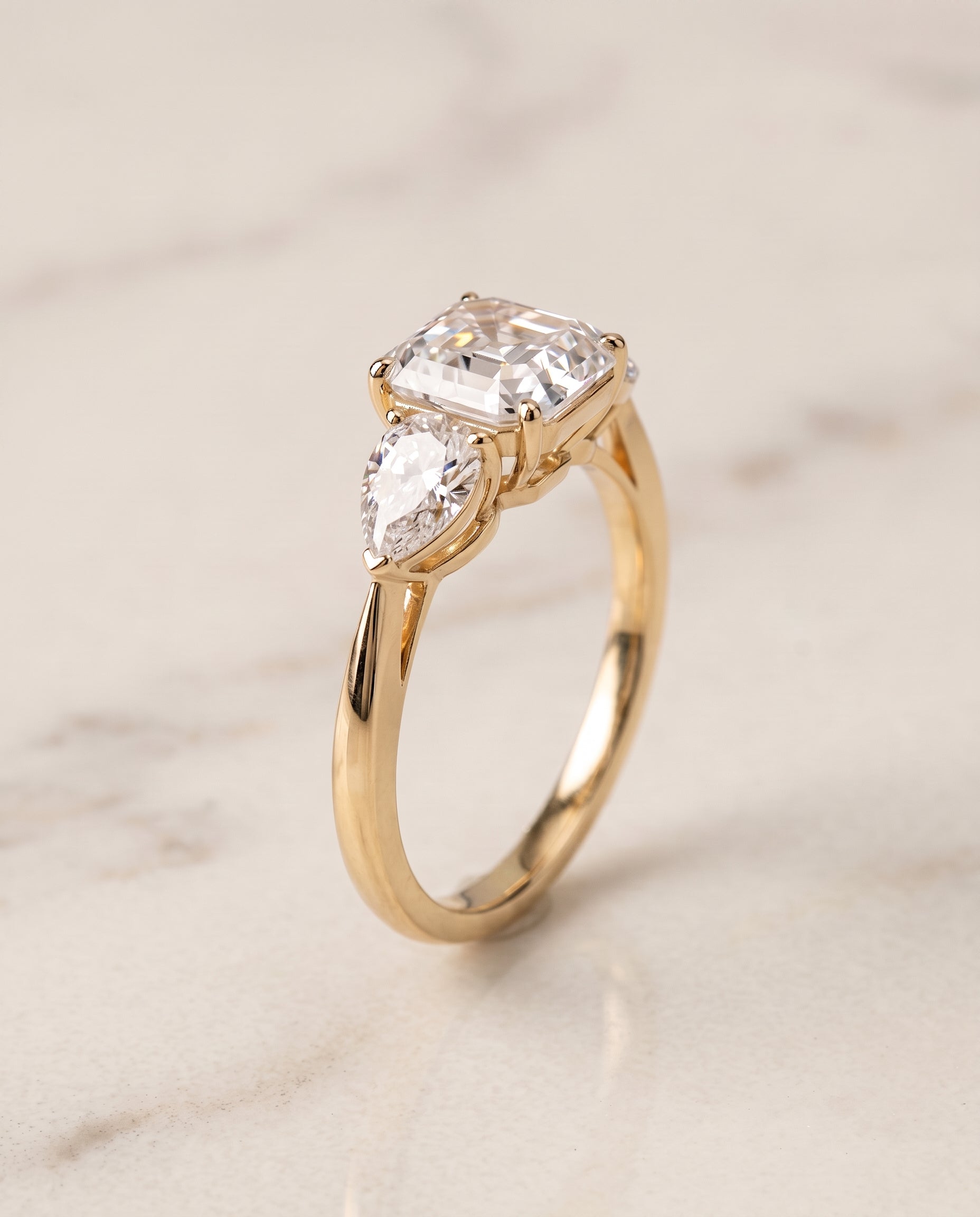 Three Stone Matched Cut styling on The Angelica asscher engagement ring setting | RockHer