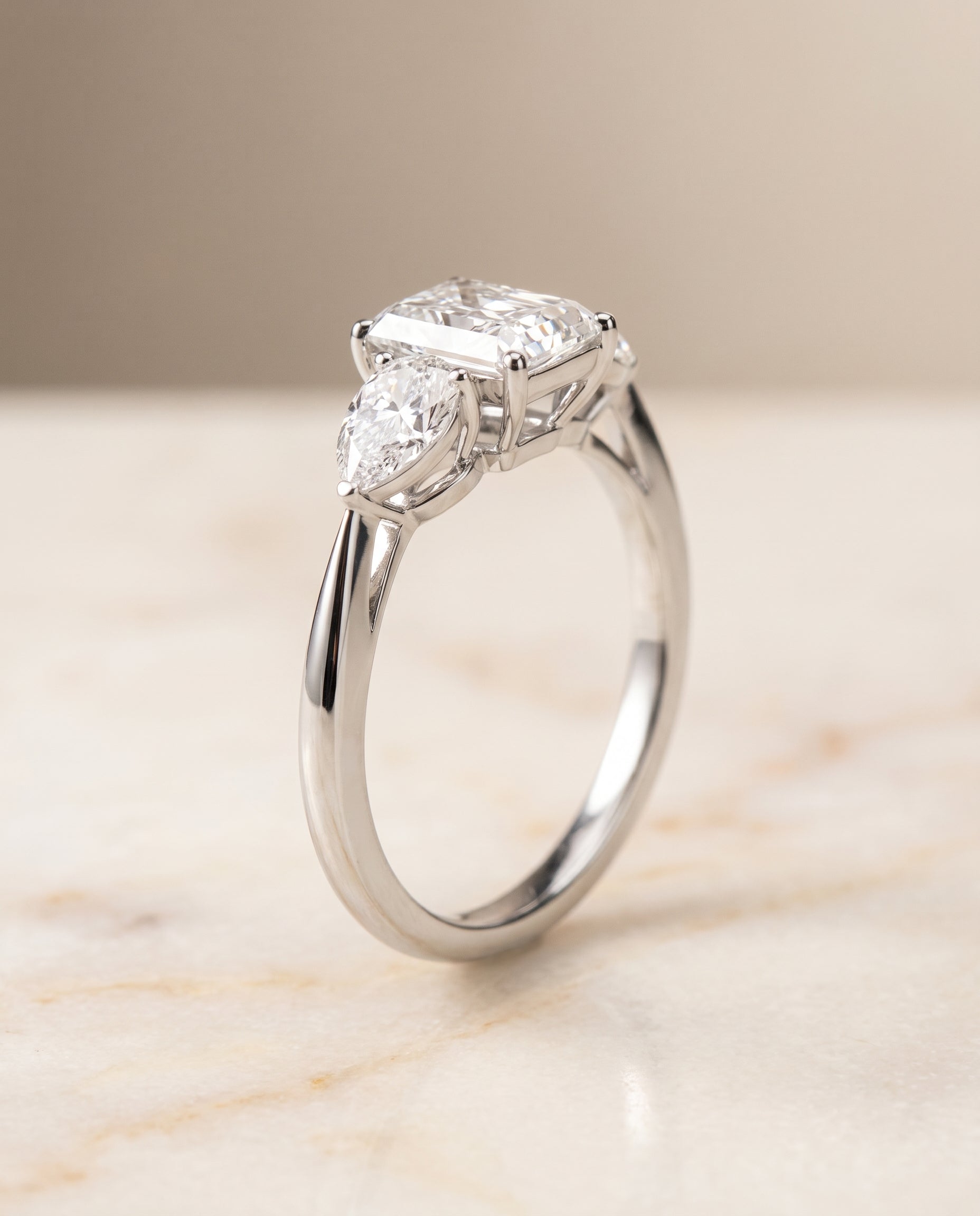 Three Stone Matched Cut styling on The Angelica radiant engagement ring setting | RockHer
