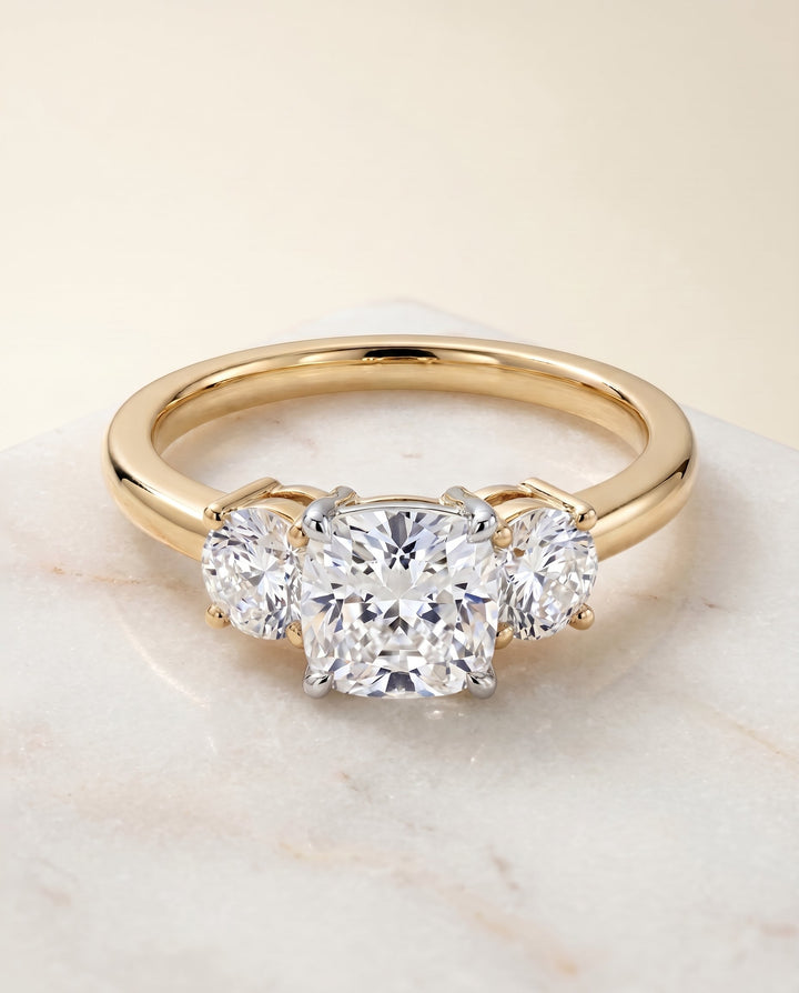 Anita Select Classic Three Stone Solitaire Round Lab Diamond Engagement Ring in 14K Yellow Gold, shown on hand, angled | RockHer