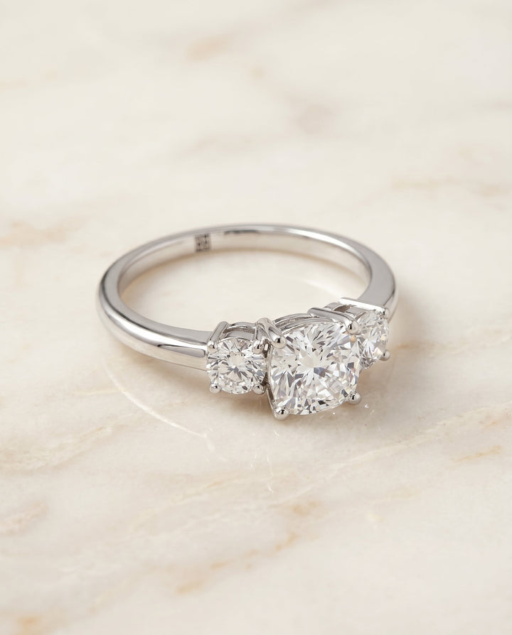 Anita Select Classic Three Stone Solitaire Round Lab Diamond Engagement Ring in Platinum, shown on hand, angled | RockHer