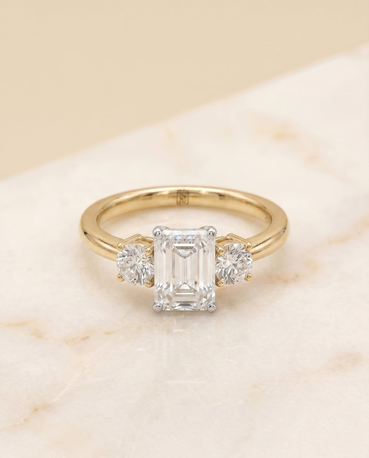 Anita Select Three Stone Emerald Cut Lab Diamond Engagement Ring in 18K Yellow Gold, shown on hand, angled | RockHer
