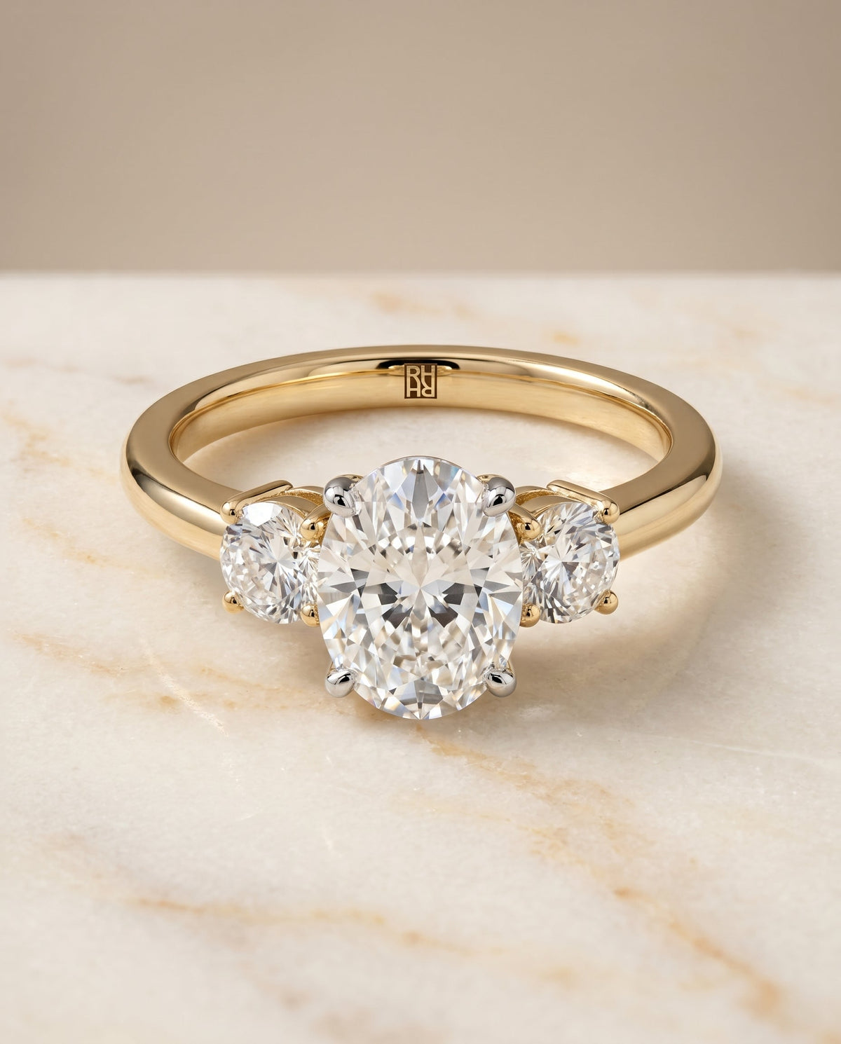 Anita Select Classic Three Stone Oval Lab Diamond Engagement Ring in 18K Yellow Gold, shown on hand, angled | RockHer
