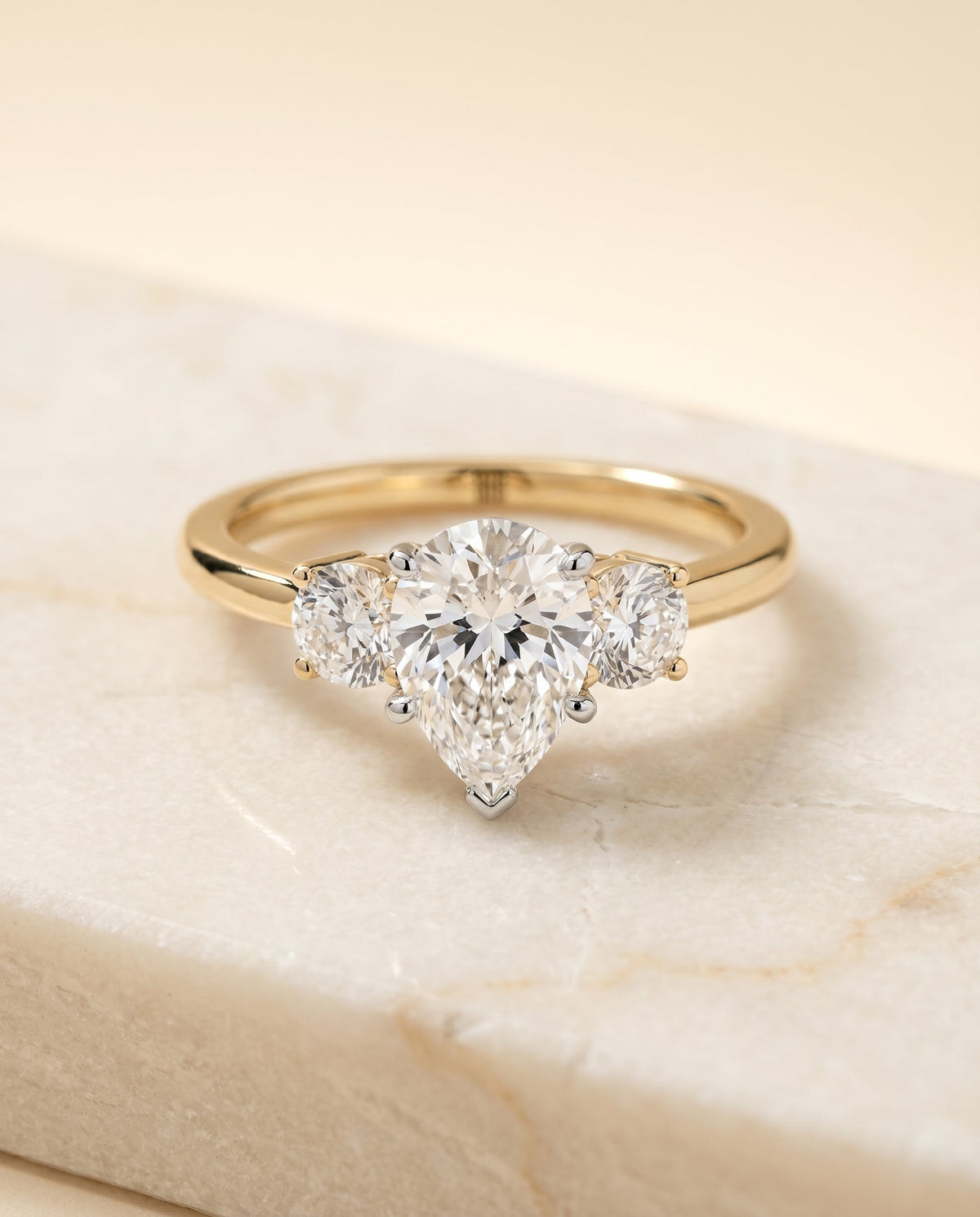 Anita Select Three Stone Pear Lab Diamond Engagement Ring in 18K Yellow Gold, shown on hand, angled | RockHer
