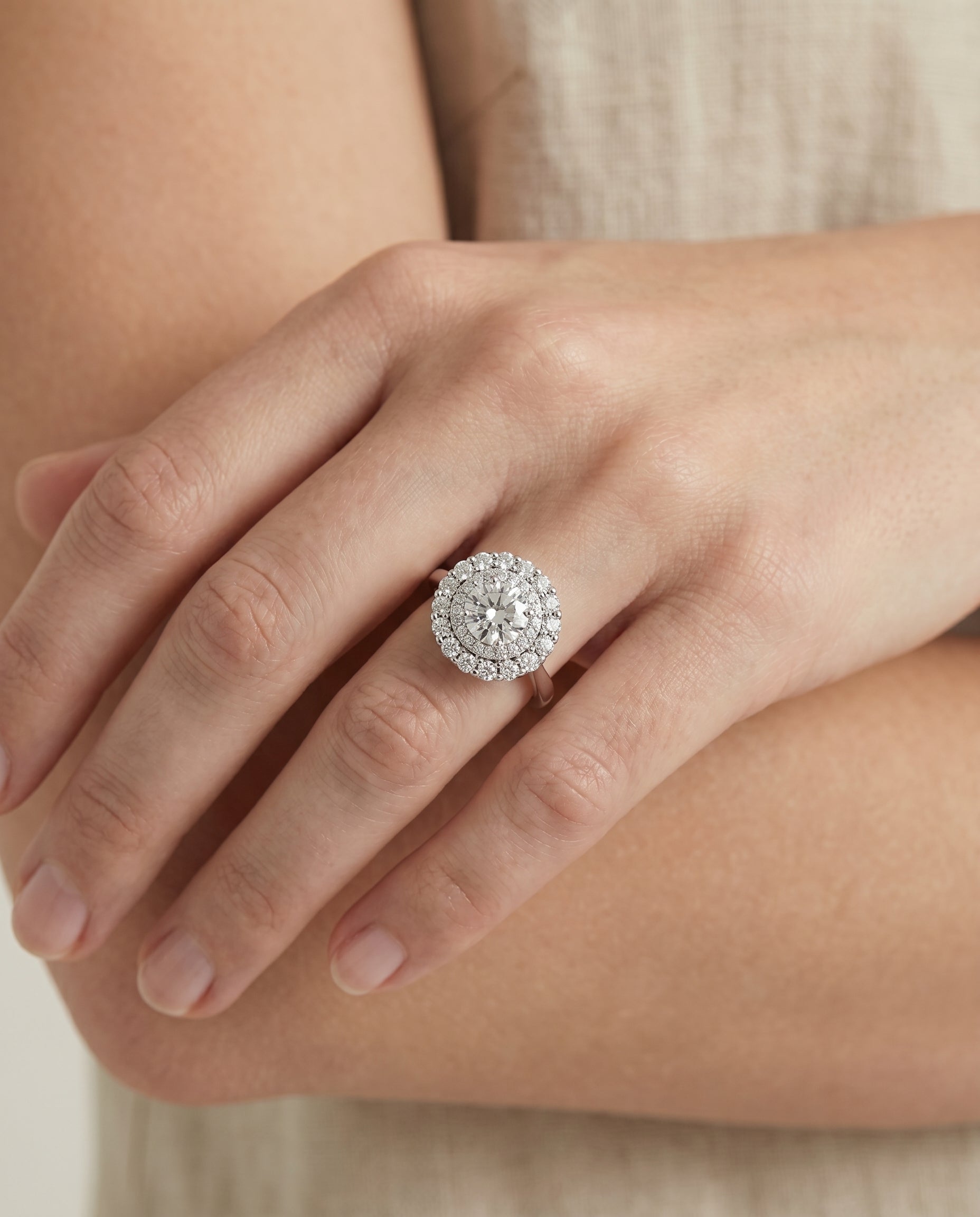 Arietta Select Double Halo Round Lab Diamond Engagement Ring in Platinum, shown on hand, angled | RockHer