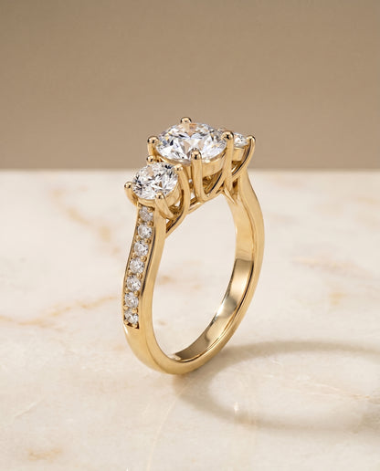 The Avery Channel Pavé Three Stone Round Engagement Ring Setting in 18K Yellow Gold