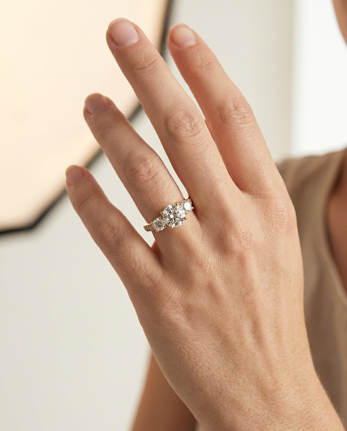 Avery Select Three Stone Round Lab Diamond Engagement Ring in 18K Yellow Gold, shown on hand | RockHer