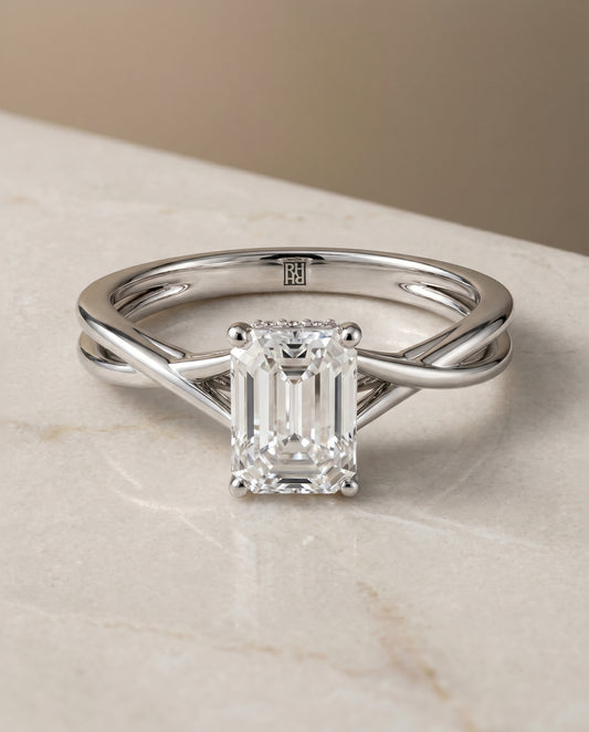 The Blondie Twisted Hidden Halo Solitaire Engagement Ring Setting for Emerald Cut Diamonds in 18K White Gold