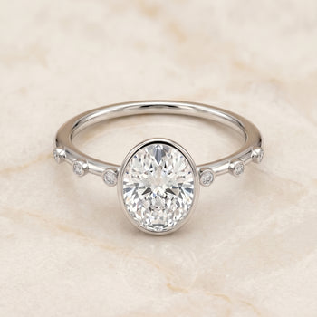 The Brandi Bezel Accent Solitaire Oval Engagement Ring Setting in 18K White Gold