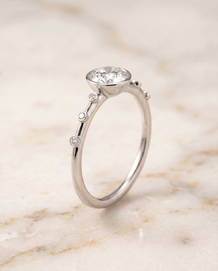 Brandi Select Bezel Accent Solitaire Round Lab Diamond Engagement Ring in 18K White Gold, front view | RockHer
