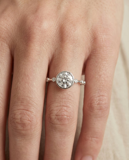 The Brandi Bezel Accent Solitaire Round Engagement Ring Setting in 18K White Gold