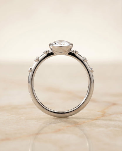 Brandi Select Bezel Accent Solitaire Round Lab Diamond Engagement Ring in 18K White Gold, side view | RockHer