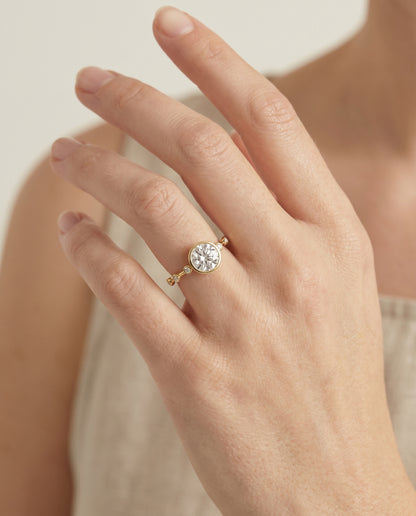 The Brandi Bezel Accent Solitaire Round Engagement Ring Setting in 18K Yellow Gold