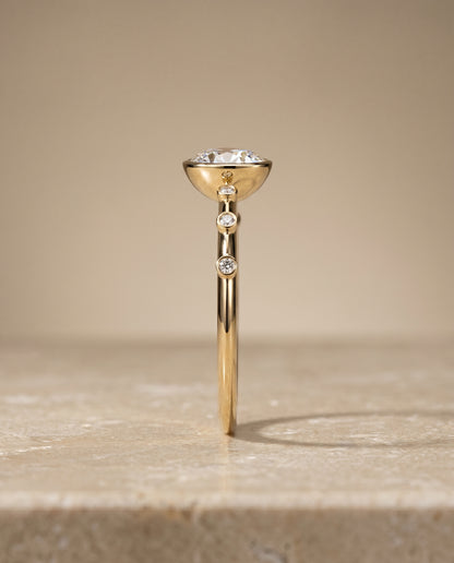 The Brandi Bezel Accent Solitaire Round Engagement Ring Setting in 18K Yellow Gold