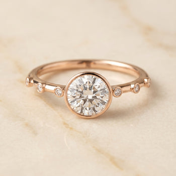 The Brandi Bezel Accent Solitaire Round Engagement Ring Setting in 14K Rose Gold