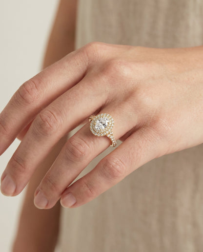 Britney Select Double Halo Oval Lab Diamond Engagement Ring in 18K Yellow Gold, shown on hand, angled | RockHer