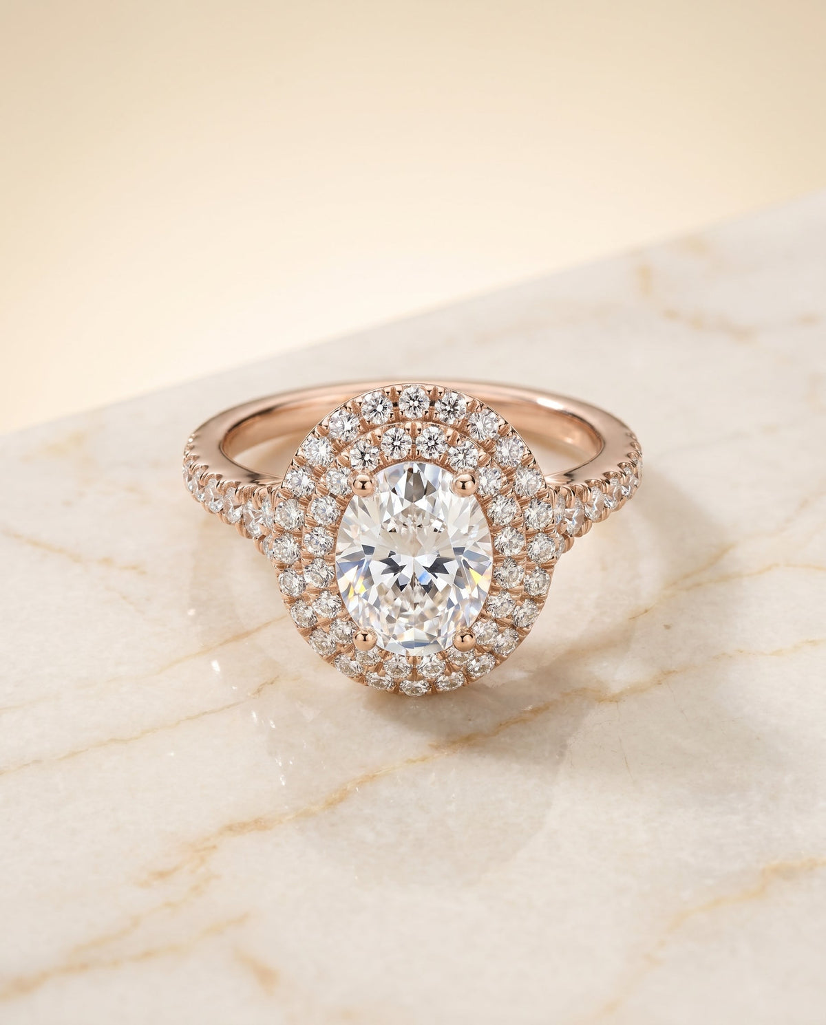 Britney Select Double Halo Oval Lab Diamond Engagement Ring in 14K Rose Gold, shown on hand, angled | RockHer