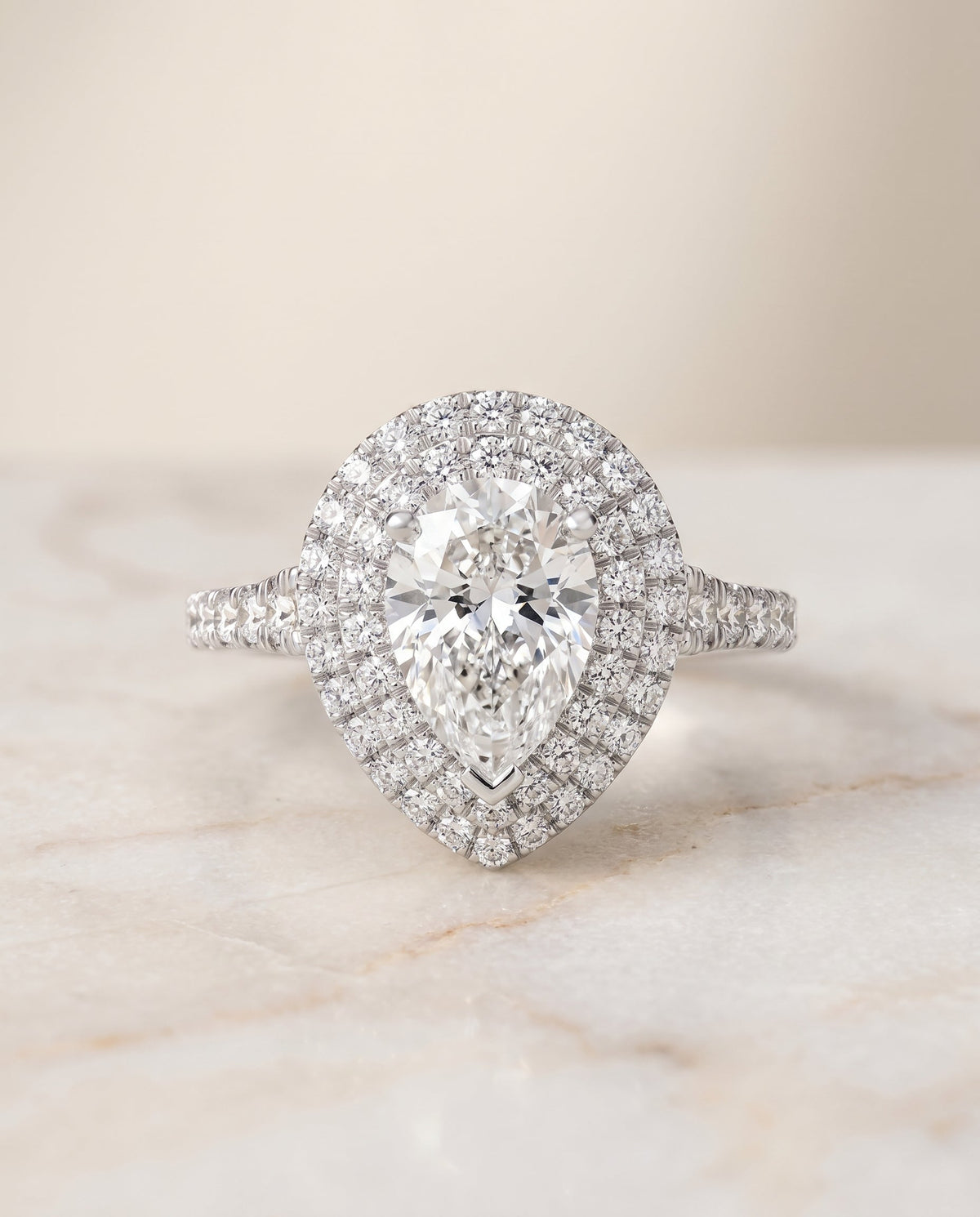 Britney Select Double Halo Pear Lab Diamond Engagement Ring in Platinum, shown on hand, angled | RockHer